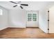Spacious bedroom featuring hardwood floors, a ceiling fan, and a bright window at 5260 Moore St, Stone Mountain, GA 30083