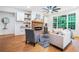 Cozy living room featuring a stone fireplace, built-in shelving, hardwood floors, and plenty of natural light at 5260 Moore St, Stone Mountain, GA 30083