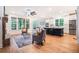 Open-concept living room with a stone fireplace, large windows, and hardwood floors at 5260 Moore St, Stone Mountain, GA 30083