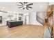 Open-concept living space with hardwood floors, a fireplace, a kitchen island, and a staircase at 5260 Moore St, Stone Mountain, GA 30083