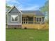 The rear exterior shows a gray home with a patio, lawn, stone accents, and stairs at 5260 Moore St, Stone Mountain, GA 30083
