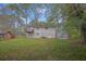 Backyard view of a two story home with a walkout basement and a wooden deck at 616 Country Lane Dr, Jonesboro, GA 30238