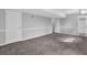 Finished basement with neutral walls, plush carpeting, and white doors at 616 Country Lane Dr, Jonesboro, GA 30238