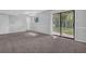 Finished basement with a sliding glass door, neutral walls, and plush carpeting at 616 Country Lane Dr, Jonesboro, GA 30238