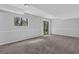 Finished basement with neutral walls, plush carpet, window, and sliding glass door at 616 Country Lane Dr, Jonesboro, GA 30238
