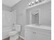 Clean bathroom featuring a shower/tub combo, toilet, and a vanity with a large mirror at 616 Country Lane Dr, Jonesboro, GA 30238
