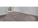 Inviting bedroom with neutral carpet and walls, with glass patio doors leading to a deck at 616 Country Lane Dr, Jonesboro, GA 30238