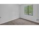 Bright bedroom features neutral walls, plush carpeting, and a window with a view at 616 Country Lane Dr, Jonesboro, GA 30238