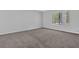 Cozy bedroom with neutral carpet, light walls, and a large window offering plenty of natural light at 616 Country Lane Dr, Jonesboro, GA 30238