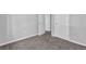 Bedroom featuring neutral walls, plush carpeting, and multiple white doors at 616 Country Lane Dr, Jonesboro, GA 30238
