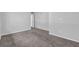 Bright bedroom features neutral walls, plush carpeting, and a white door at 616 Country Lane Dr, Jonesboro, GA 30238