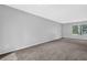 Neutral bedroom with gray carpet, light walls, and a large window bringing in plenty of natural light at 616 Country Lane Dr, Jonesboro, GA 30238