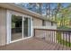Wooden deck with a sliding glass door and views of the surrounding trees at 616 Country Lane Dr, Jonesboro, GA 30238