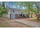 Two-story home with brick accents, light siding, and a long driveway leading up to the front entrance at 616 Country Lane Dr, Jonesboro, GA 30238