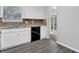 Bright kitchen featuring white cabinets, black dishwasher, and plenty of counter space at 616 Country Lane Dr, Jonesboro, GA 30238