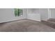 Bright living room featuring neutral paint, modern carpet, and a large window providing ample natural light at 616 Country Lane Dr, Jonesboro, GA 30238