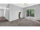 Open concept living room with neutral carpet and a view of the kitchen and outdoor deck at 616 Country Lane Dr, Jonesboro, GA 30238