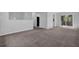 Spacious living room with modern carpet and sliding glass doors leading to outdoor deck area at 616 Country Lane Dr, Jonesboro, GA 30238