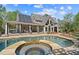Backyard view of the property featuring an inground pool with a large covered patio area at 2839 Echols Rd, Cumming, GA 30041