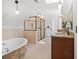 Bright bathroom features tub, shower, granite countertops and travertine tile at 2839 Echols Rd, Cumming, GA 30041