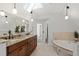Bright bathroom features double sink, soaking tub, and travertine tile at 2839 Echols Rd, Cumming, GA 30041