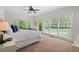 Bright bedroom featuring large windows, a ceiling fan, and neutral decor at 2839 Echols Rd, Cumming, GA 30041