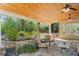Charming covered patio with flagstone and outdoor seating, surrounded by lush landscaping at 2839 Echols Rd, Cumming, GA 30041