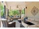 Relaxing covered patio with a porch swing, ample seating, and a neutral color palette at 2839 Echols Rd, Cumming, GA 30041