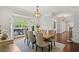 Dining room with large bay window, elegant chandelier, and seating for six at 2839 Echols Rd, Cumming, GA 30041