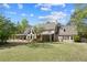 Beautiful two-story home with well-manicured lawn, mature trees, and charming covered patio at 2839 Echols Rd, Cumming, GA 30041