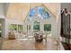 Open living area featuring soaring ceilings, natural light, and travertine flooring at 2839 Echols Rd, Cumming, GA 30041