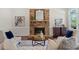Cozy living room with a stone fireplace, plush seating, and natural light from the windows at 2839 Echols Rd, Cumming, GA 30041