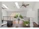 Loft area overlooking the living room with a desk, black iron railing, and wood floors at 2839 Echols Rd, Cumming, GA 30041
