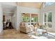 Inviting sitting area featuring tan stone floors, lots of light, and neutral furnishings at 2839 Echols Rd, Cumming, GA 30041