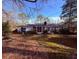 Charming ranch-style home with a welcoming porch, nestled on a wooded lot with mature trees at 214 S Lake Dr, Hiram, GA 30141