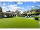 Expansive backyard showcasing a pool, lush green lawn, and mature trees, offering a serene outdoor escape at 315 Peachtree Battle Nw Ave, Atlanta, GA 30305