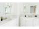 Elegant bathroom featuring dual vanities, pristine white cabinets, and modern fixtures at 315 Peachtree Battle Nw Ave, Atlanta, GA 30305