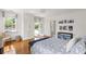 Bedroom features a large window, hardwood floors, and a blue patterned coverlet at 315 Peachtree Battle Nw Ave, Atlanta, GA 30305