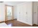 Bright bedroom features large built-in wardrobe, hardwood floors, and a light-filled ambiance at 315 Peachtree Battle Nw Ave, Atlanta, GA 30305