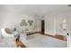 Stylish bedroom featuring a chandelier, bench, wardrobe, and unique butterfly artwork on the light neutral walls at 315 Peachtree Battle Nw Ave, Atlanta, GA 30305