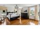 Bedroom featuring a dark wood bed frame, chandelier, hardwood floors, and large windows at 315 Peachtree Battle Nw Ave, Atlanta, GA 30305