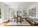 Elegant dining room featuring hardwood floors, stylish furnishings, and French doors leading to outdoor views at 315 Peachtree Battle Nw Ave, Atlanta, GA 30305