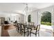 Bright dining room with hardwood floors, white walls, chandelier, and access to the patio through arched glass doors at 315 Peachtree Battle Nw Ave, Atlanta, GA 30305
