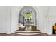 Elegant entryway with hardwood floors and arched doorway to the outdoor dining area adds architectural interest at 315 Peachtree Battle Nw Ave, Atlanta, GA 30305