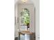 Elegant arched entryway with a glass-paneled door leading to a lush outdoor view at 315 Peachtree Battle Nw Ave, Atlanta, GA 30305