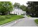 Elegant white home with manicured lawn, stone steps, and beautiful landscaping at 315 Peachtree Battle Nw Ave, Atlanta, GA 30305
