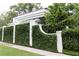 Property featuring an ivy-covered wall with brick columns, enhancing privacy and curb appeal on the street at 315 Peachtree Battle Nw Ave, Atlanta, GA 30305
