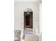 A hallway with black and white checkered tile floors, natural lighting and dark wood features at 315 Peachtree Battle Nw Ave, Atlanta, GA 30305
