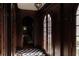 Elegant hallway with dark wood accents, arched doorways, and a checkered tile floor at 315 Peachtree Battle Nw Ave, Atlanta, GA 30305