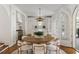 Open-concept kitchen with white cabinets and an island features a round table and backyard access at 315 Peachtree Battle Nw Ave, Atlanta, GA 30305